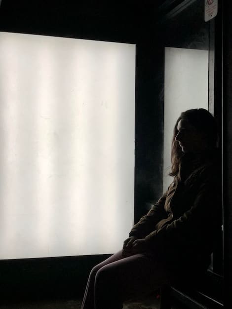 A close-up shot of a film critic in a dimly lit screening room, intently watching a movie on the screen. The critic is holding a notepad and pen, subtly illuminated by the screen's glow, capturing a moment of focused analysis and reflection.