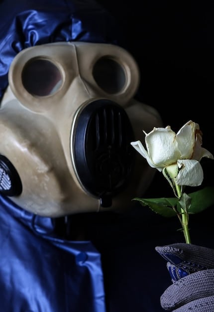 A close-up shot of Bane's mask, focusing on the intricate details of the breathing apparatus and the menacing expression conveyed by the eyes. The lighting is dim and ominous, emphasizing the character's villainous nature.
