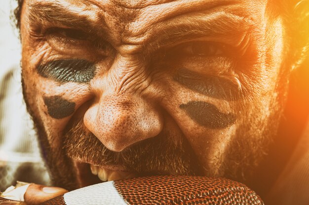 A close-up shot of Jim Carrey as Truman Burbank, showing a mix of determination and fear in his eyes, as he sails towards the edge of his world, ready to confront the unknown.