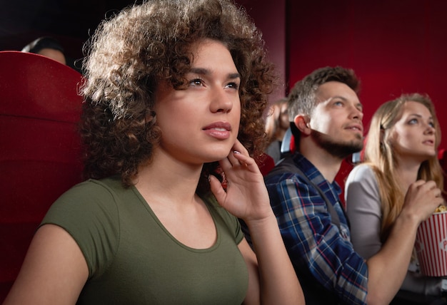A group of young adults looking stressed and overwhelmed, surrounded by the busy environment of a film set, highlighting the pressures they face in the entertainment industry.