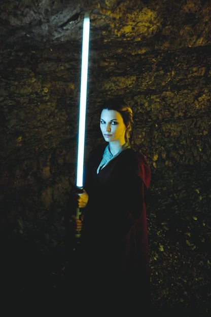A dramatic scene of Anakin Skywalker's face, half illuminated with the blue light of the Jedi and half shrouded in the red of the Sith, reflecting his internal conflict and descent into Darth Vader.