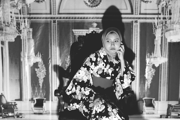 A black-and-white still from a classic Korean melodrama film. The scene features an iconic actress known for her roles in melodramas, with a sorrowful expression. The image captures the vintage aesthetic and emotional intensity of the genre's early days.